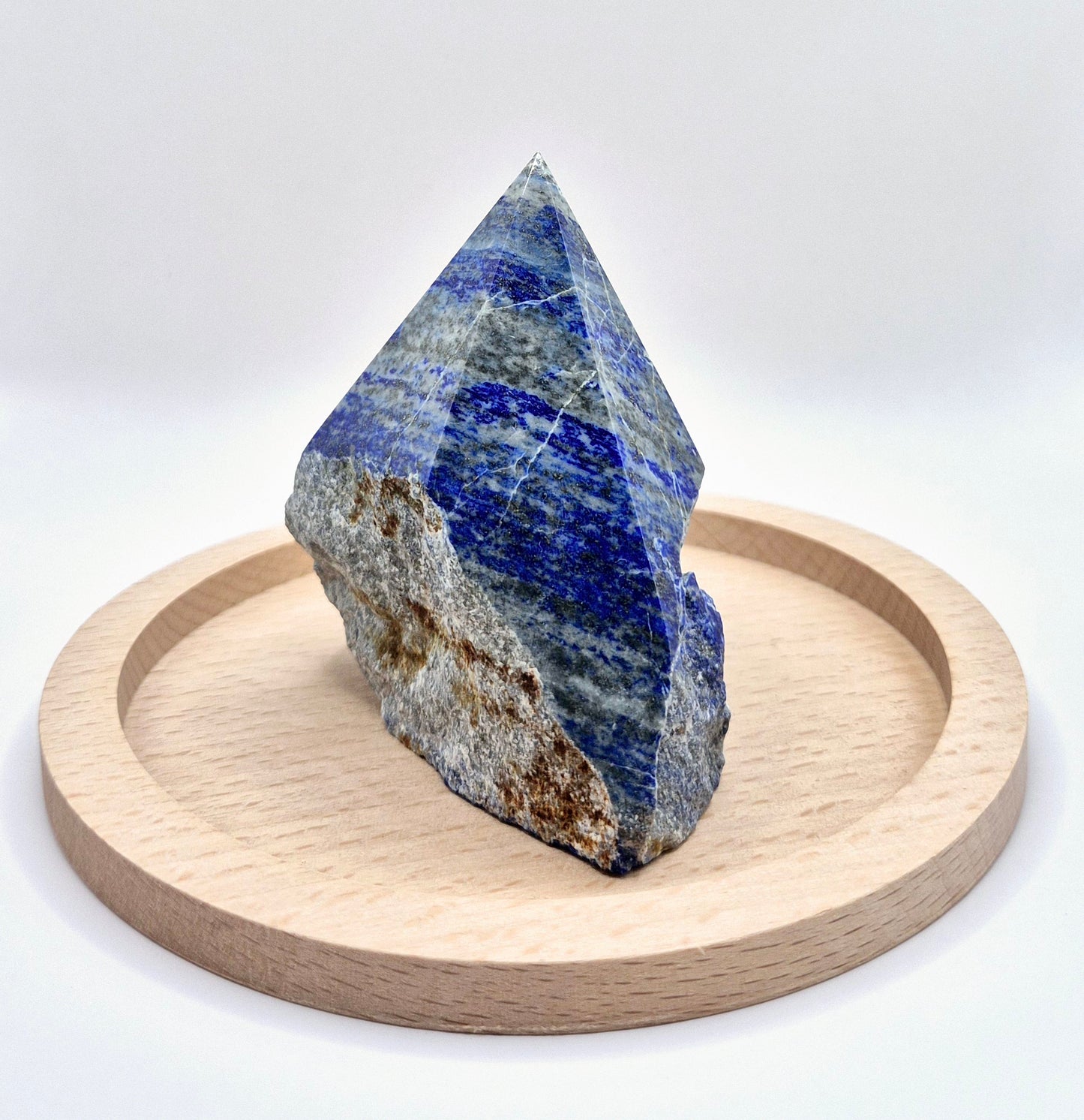 Lapis Lazuli Point (Half Raw, Half Polished)
Unlock your inner wisdom with this Lapis Lazuli Point, blending raw beauty with polished elegance. Lapis Lazuli is a stone of truth and enlightenment, known for enhancing intellectual ability and deepening spiritual insight. The polished top reveals its deep blue hues speckled with golden pyrite, while the raw base keeps its energy grounded and authentic. While Lapis Lazuli can handle brief water contact, it's best to avoid prolonged exposure to protect its deli