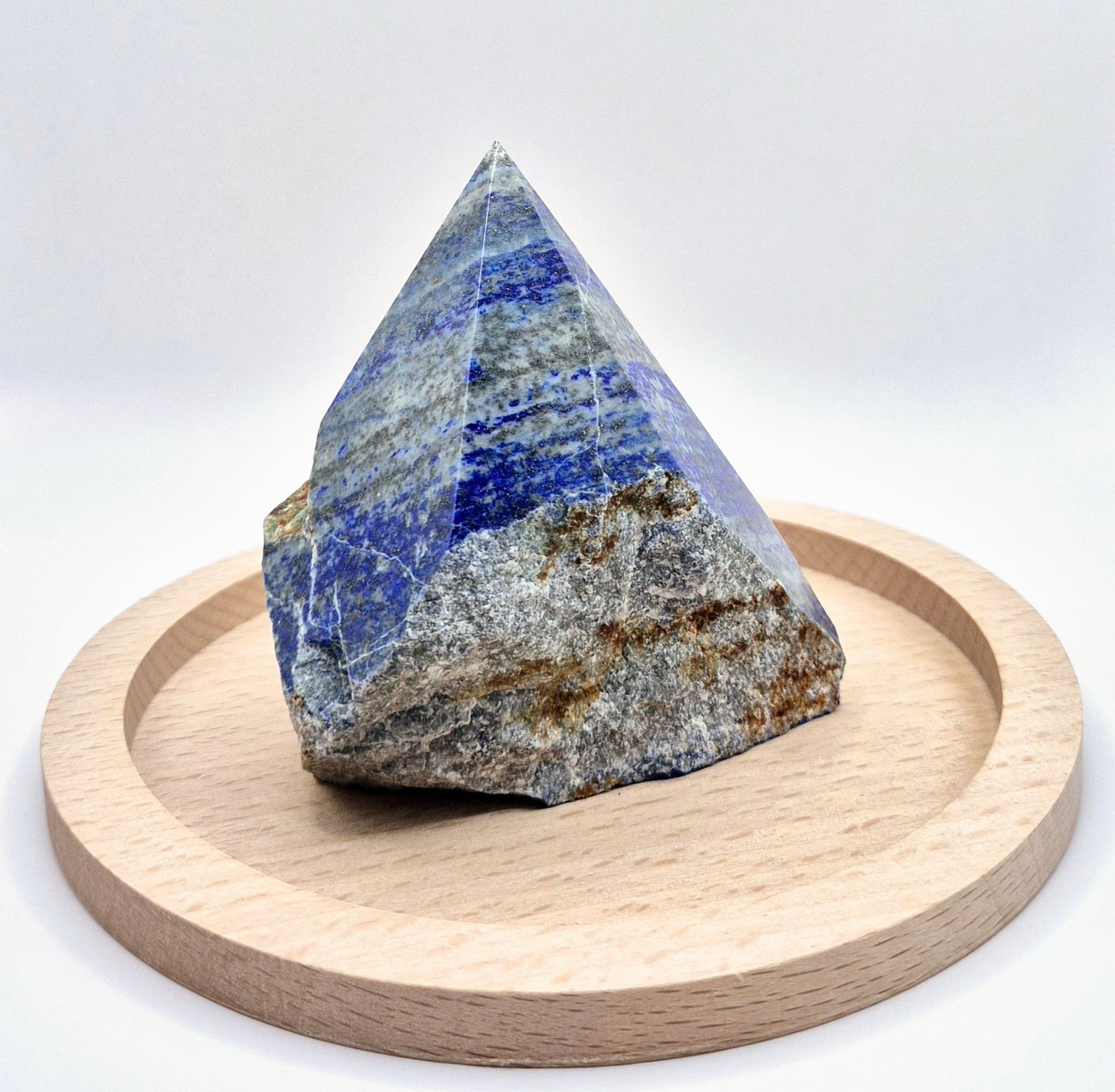 Lapis Lazuli Point (Half Raw, Half Polished)
Unlock your inner wisdom with this Lapis Lazuli Point, blending raw beauty with polished elegance. Lapis Lazuli is a stone of truth and enlightenment, known for enhancing intellectual ability and deepening spiritual insight. The polished top reveals its deep blue hues speckled with golden pyrite, while the raw base keeps its energy grounded and authentic. While Lapis Lazuli can handle brief water contact, it's best to avoid prolonged exposure to protect its deli