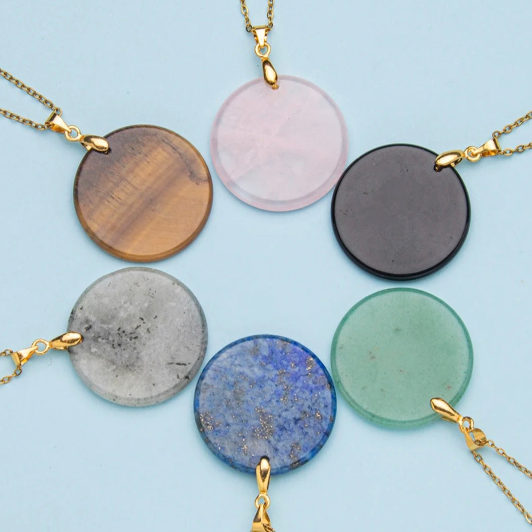 Vergulde ketting met ronde edelsteen hanger van 3 cm in verschillende steensoorten waaronder rozenkwarts, aventurijn, labradoriet en tijgeroog.